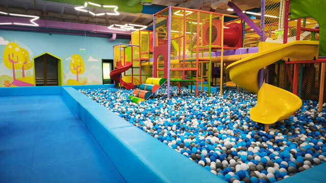Indoor play area for kids at the playground. A bright and safe indoor playground with lots of tubes, a ball pit, tunnels, and endless fun.
