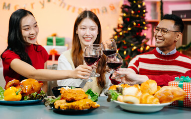 Asian friends capture the holiday spirit with gifts, laughter, and a festive Christmas dinner in a cozy, joy-filled setting