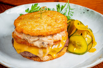 Crispy potato cakes with juicy beef and melted cheese, served with pickles