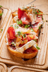 Freshly prepared bread slice adorned with colorful toppings at a charming bistro setting