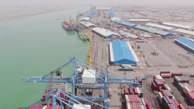 Aerial view highlights bustling port operations with cranes and ships, Northern Umm Qasr port in Basra, Iraq.