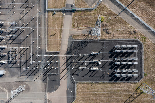 Aerial drone picture of large electric power substation and high voltage power lines in Hillsboro Oregon, showing transmission towers, transformers, and distribution infrastructure from above