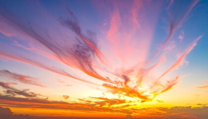 Fototapeta premium A vibrant sunset paints the sky with hues of orange, pink, and purple, creating a stunning natural spectacle. Clouds streak across a blue canvas