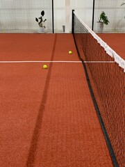 Paddle tennis balls of a red field rubber ground with white lines outdoors, sports concept.