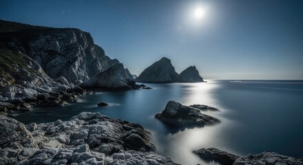 Bright moon reflects on calm sea, illuminating rugged cliffs and distant islets at night