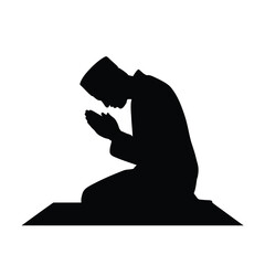 Black silhouette of a man praying on a mat kneeling