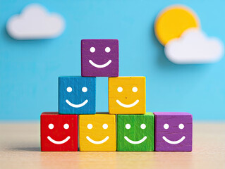 Colorful Wooden Blocks Stacked in Pyramid Shape with Smiley Faces Background
