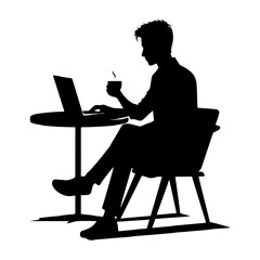 Silhouette of a man working on a laptop at a desk