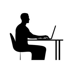 Silhouette of a man working on a laptop at a desk