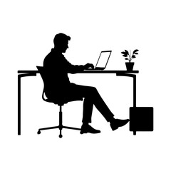 Silhouette of a man working on a laptop at a desk