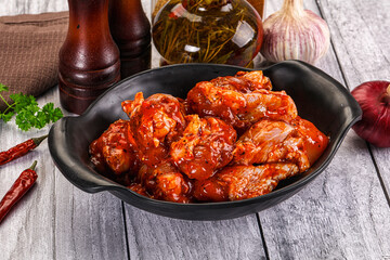 Raw marinated buffalo chicken wings