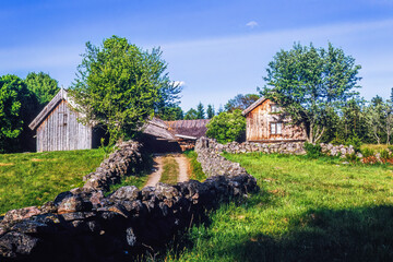 Old farmhouse on a hill with meadows and stone walls