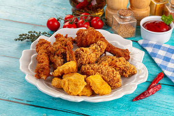 Golden crispy fried chicken mix - wings, drumsticks, nuggets and strips