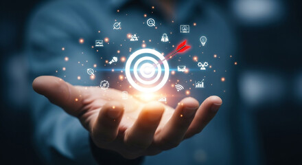 Fototapeta premium Hand holding glowing target with digital icons representing data and success