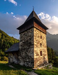 Stone tower church, trees, cloudy sky