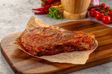 Raw marinated pork loin steak