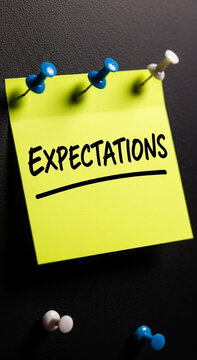 Yellow sticky note with the word expectations written in black marker
