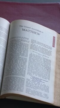The book of Matthew of the new testament, Holy Bible. Printed form. High angle, vertical video.