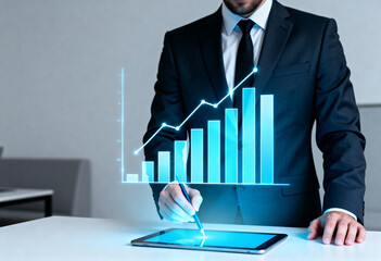 A businessman in a suit interacts with a glowing blue chart on a tablet.