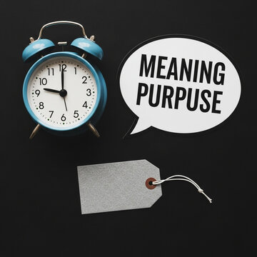 Alarm clock and speech bubble with words meaning and purpose
