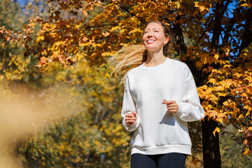 Young beautiful girl jogging in city beautiful autumn park and forest enjoy outdoor sports. 