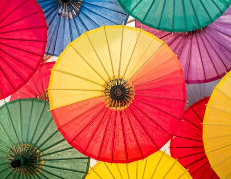 Vibrant paper umbrellas in various colors - Powered by Adobe