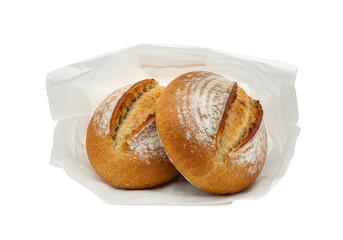 Isolated round bread loaves dusted with flour inside a paper bag on seamless backdrop