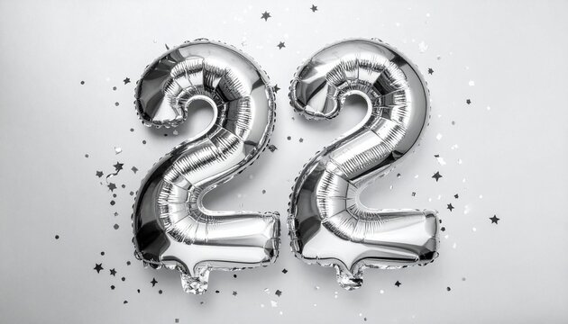 Silver balloon number 22 with confetti on solid colored background. Photo for anniversary or birthday party