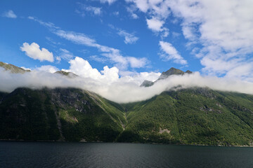 Hjorundfjord with a view of the breathtaking Sunnmore Alps, one of Norway's most famous mountain regions  