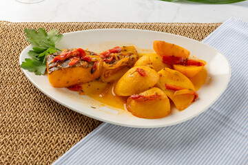 Portuguese codfish dish with roasted peppers and potatoes
