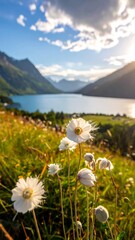Fototapeta premium Scenic view of a lake nestled between mountains, wildflowers in the foreground