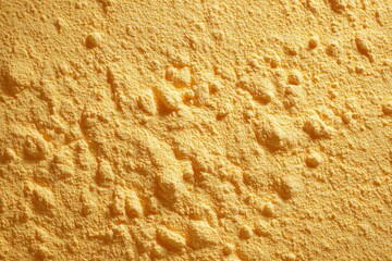 Golden Powder Texture: Close-up shot captures the intricate patterns of a fine, golden powder, the texture inviting curiosity and evoking warmth and subtle delight.