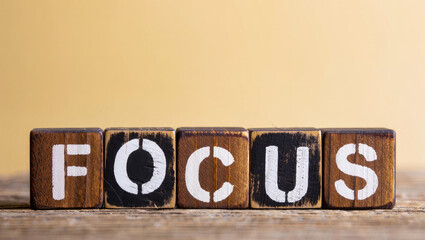Wooden Blocks Spelling Focus on Wooden Surface with Cream Background