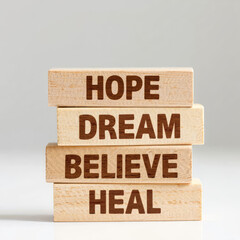 Wooden blocks spelling Hope Dream Believe Heal for inspirational concepts