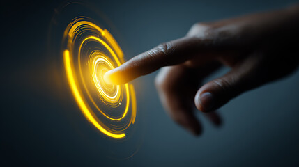 Close-up view of a human hand touching and interacting with a bright yellow circular digital interface icon, futuristic user interface design