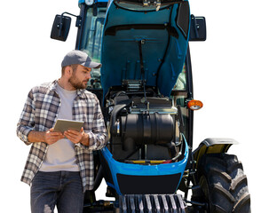 Fototapeta premium Male mechanic with digital tablet inspecting tractor.