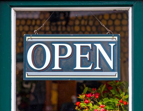 Vintage shop sign displaying the word "OPEN. - Powered by Adobe