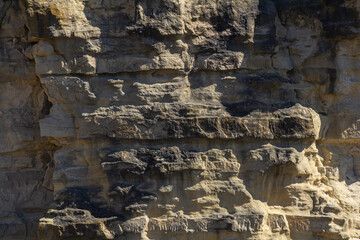 Rock formations in natural setting showcase fascinating textures and colors during bright daylight at a secluded outdoor location
