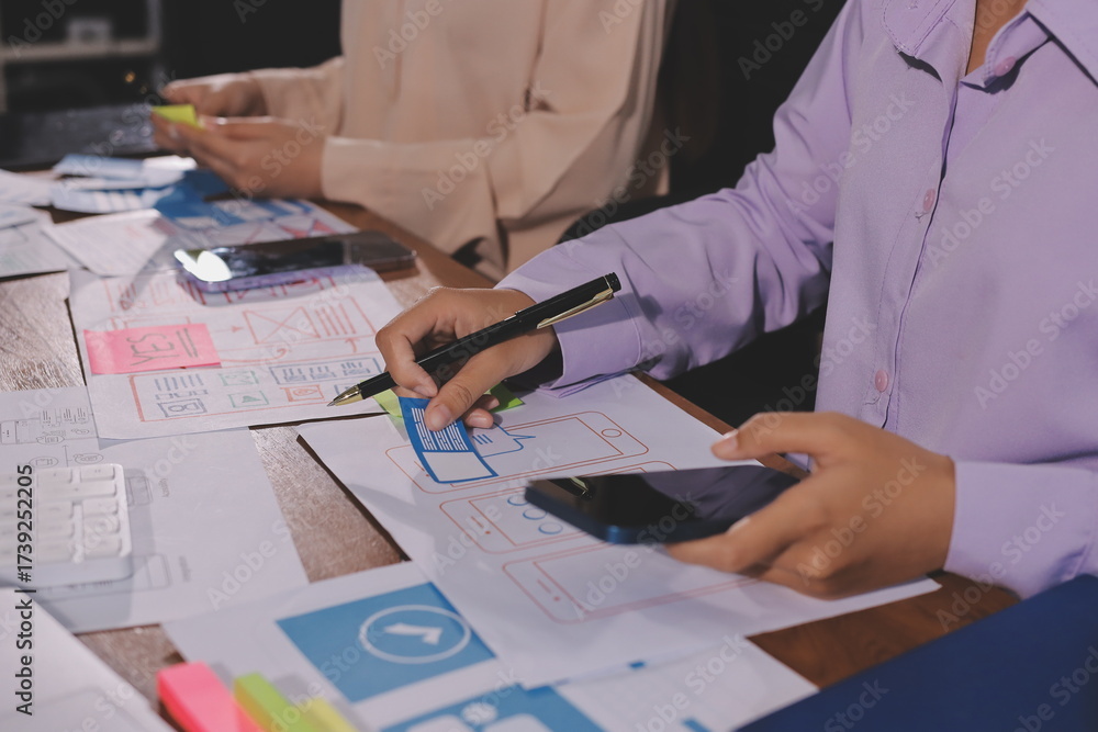 Wall mural close up ux developer and ui designer brainstorming about mobile app interface wireframe design on t