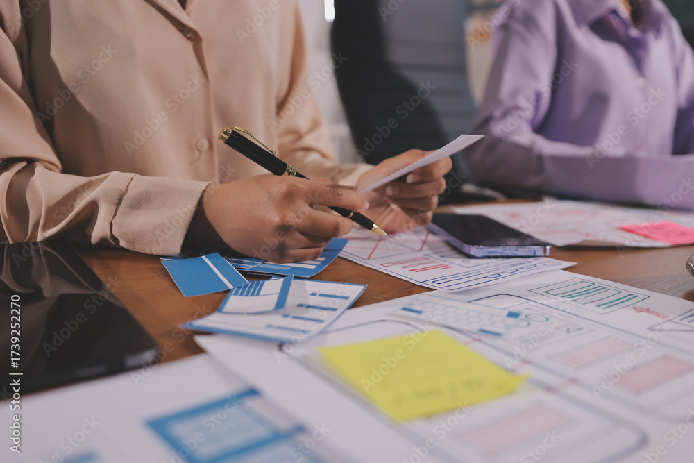 Wall mural close up ux developer and ui designer brainstorming about mobile app interface wireframe design on t