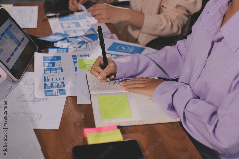 Wall mural close up ux developer and ui designer brainstorming about mobile app interface wireframe design on t