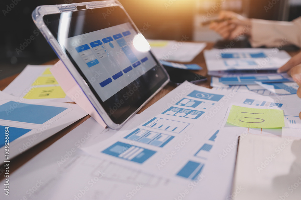 Wall mural close up ux developer and ui designer brainstorming about mobile app interface wireframe design on t