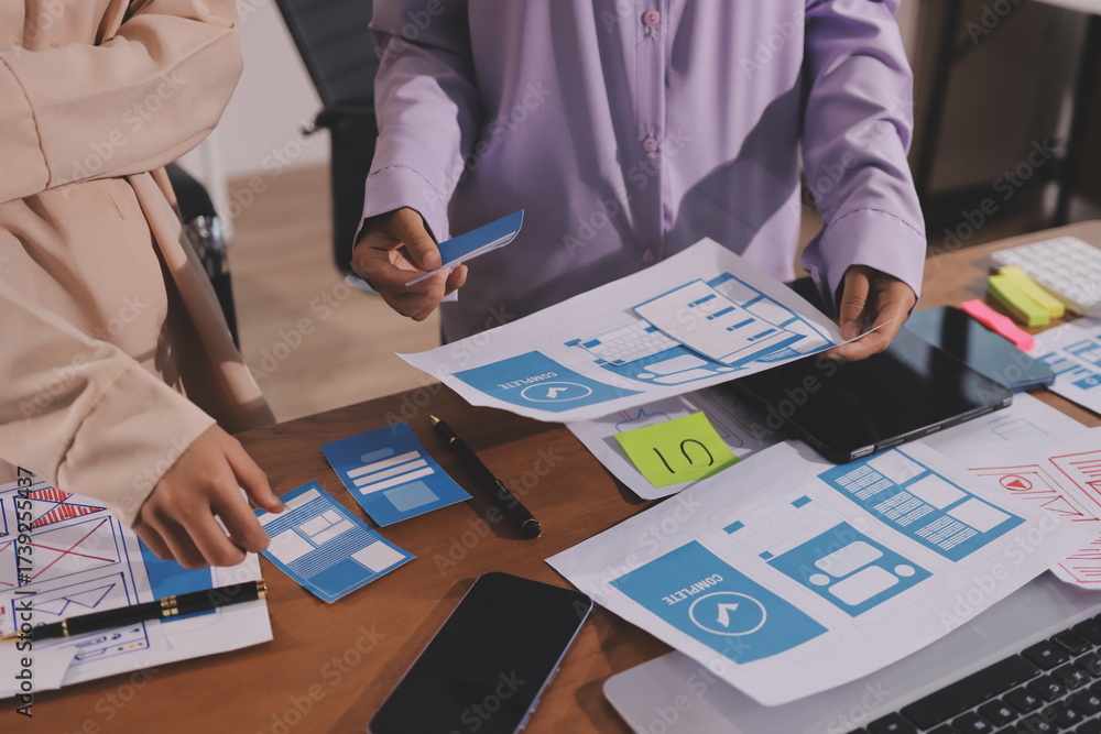 Wall mural close up ux developer and ui designer brainstorming about mobile app interface wireframe design on t