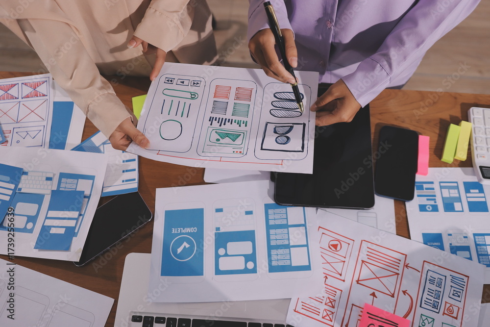 Wall mural close up ux developer and ui designer brainstorming about mobile app interface wireframe design on t
