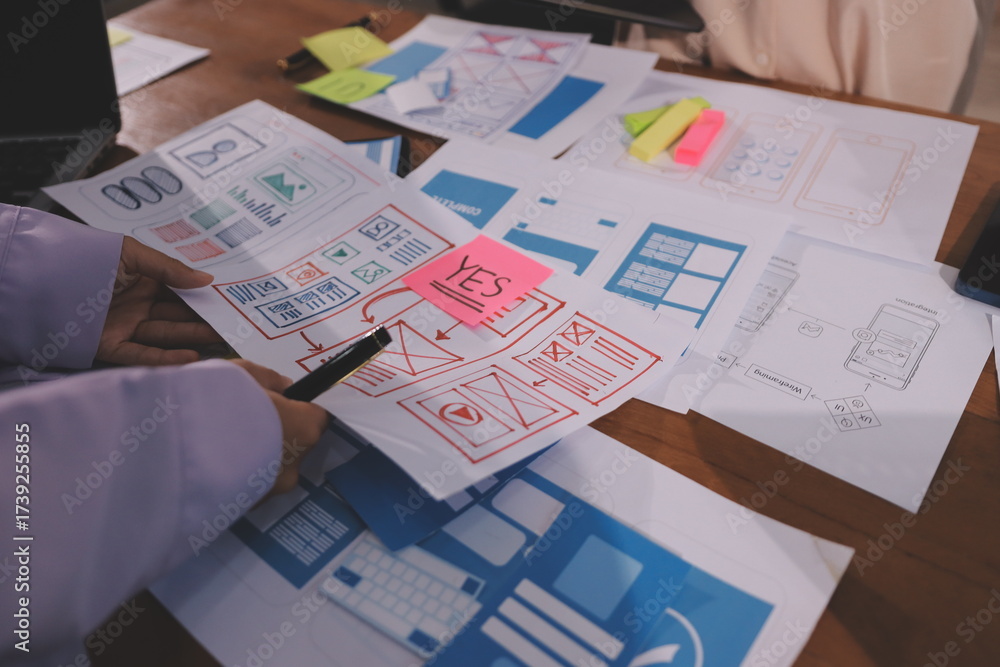 Wall mural close up ux developer and ui designer brainstorming about mobile app interface wireframe design on t