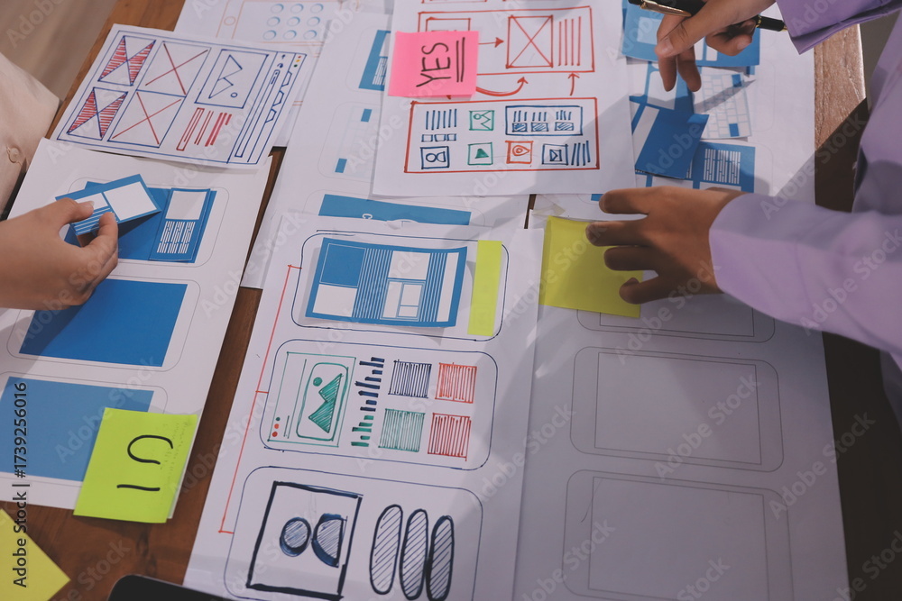 Wall mural close up ux developer and ui designer brainstorming about mobile app interface wireframe design on t