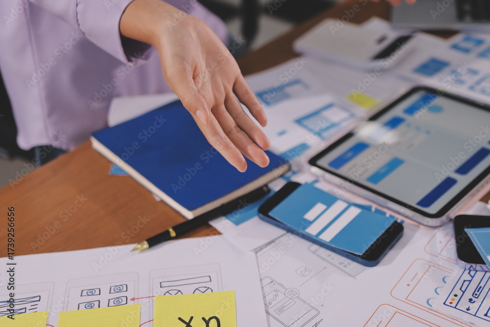 Wall mural close up ux developer and ui designer brainstorming about mobile app interface wireframe design on t