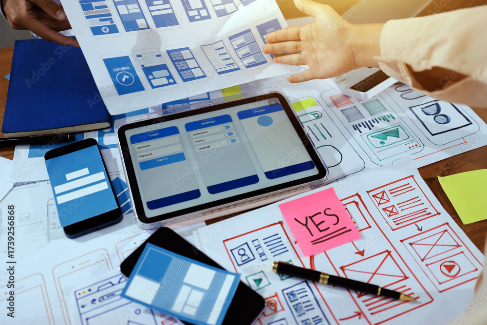 Wall mural close up ux developer and ui designer brainstorming about mobile app interface wireframe design on t
