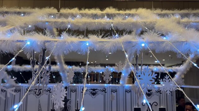 4k footage close up of lighted Christmas tree house decoration with sparkling icicle lights and white tinsels. Interactive sparkling christmas twinkle lights or icicle lights. Merry Christmas