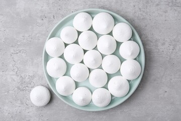 Yummy meringue cookies on grey table, top view